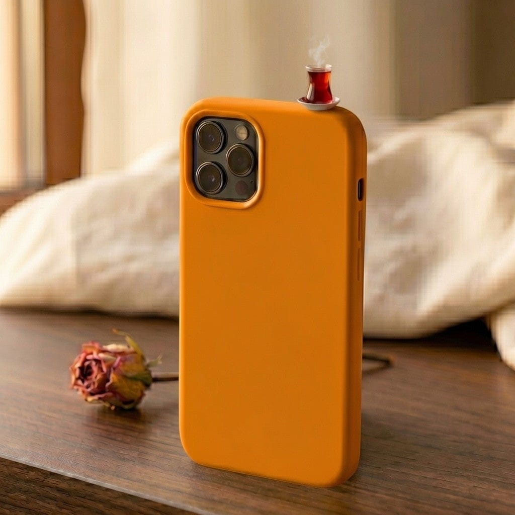 digitaley.co orange silicone iPhone case with a miniature tea glass motif and steam detail.