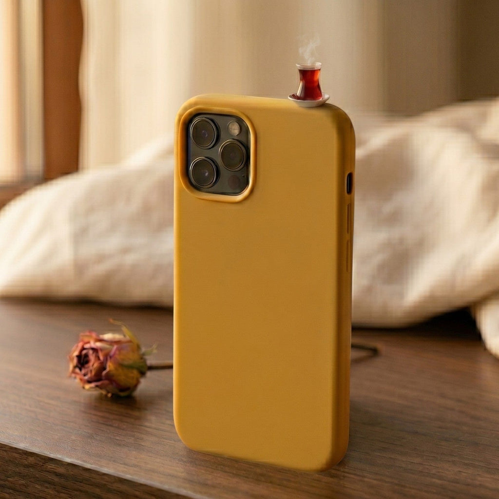 digitaley.co mustard yellow silicone iPhone case with a miniature tea glass motif on top. Features camera cutout.