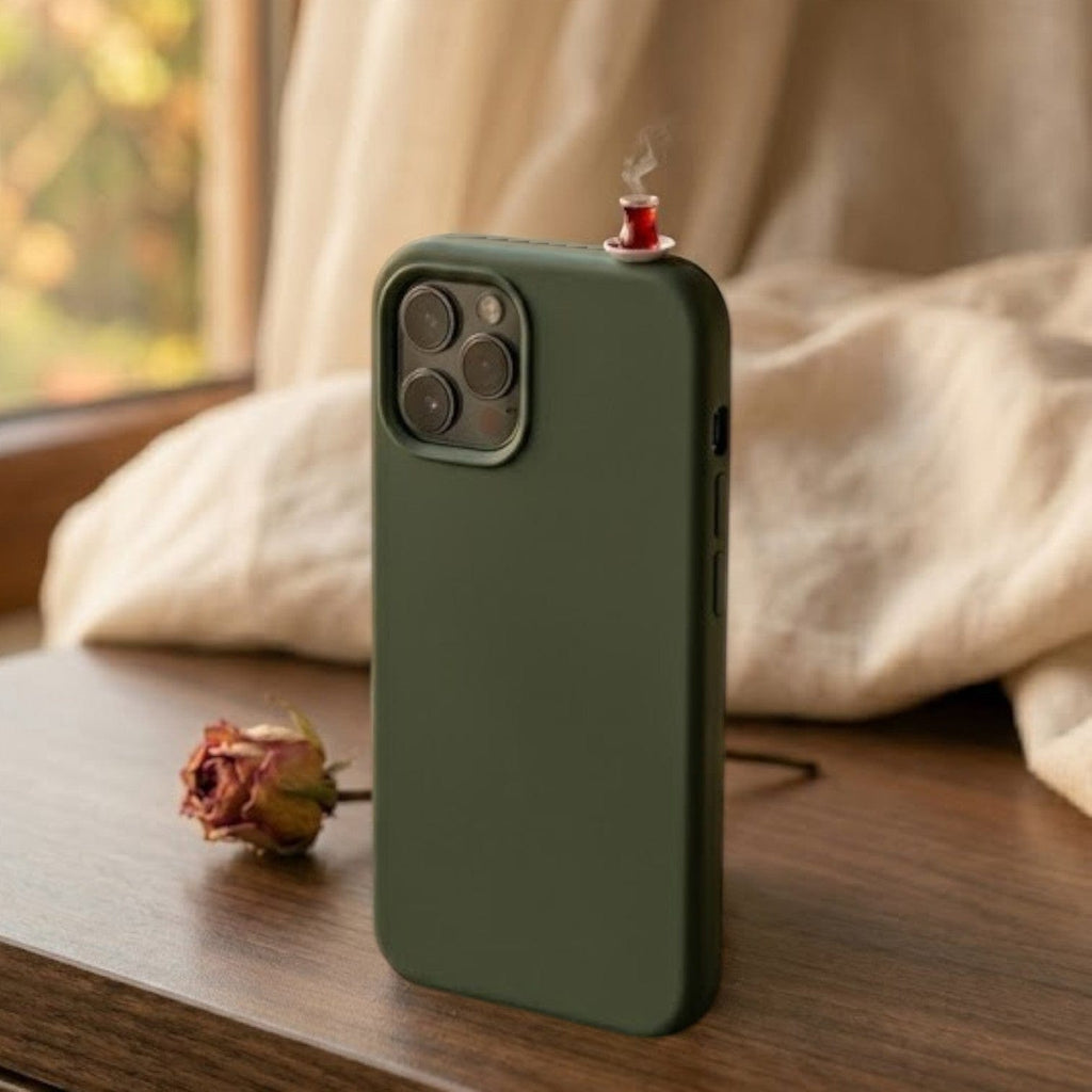 digitaley.co dark green silicone iPhone case with a miniature tea glass motif and steam detail.
