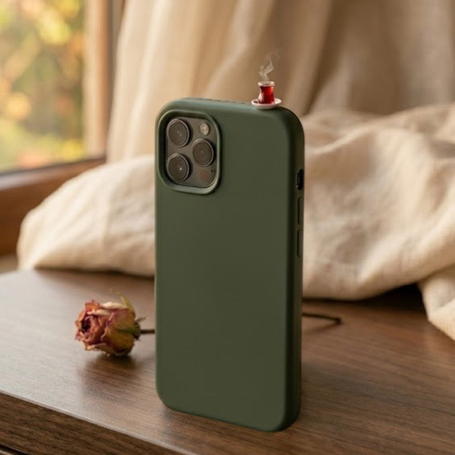 digitaley.co dark green silicone iPhone case with a miniature tea glass motif and steam detail.