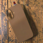 digitaley.co brown silicone iPhone case with a 3D slim-waist tea glass motif on a wooden background.