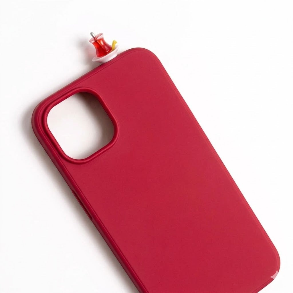 Red iPhone case with a 3D miniature Turkish tea glass and saucer charm. Handmade cultural accessory.